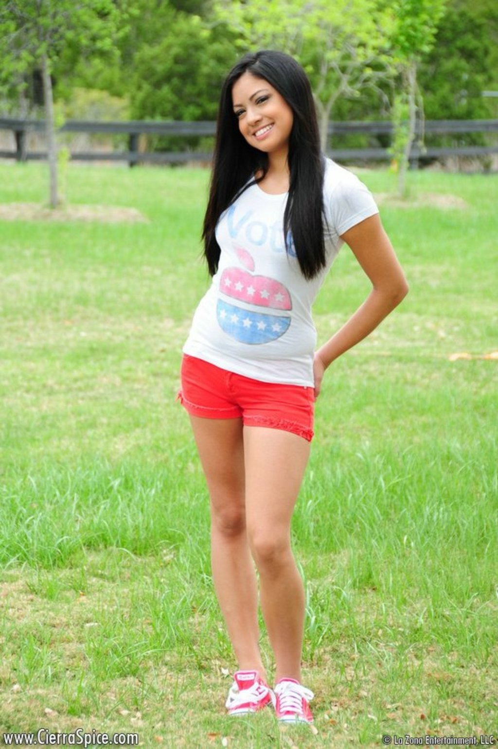 Young Latina Beauty Cierra Spice Strips In A Park 01